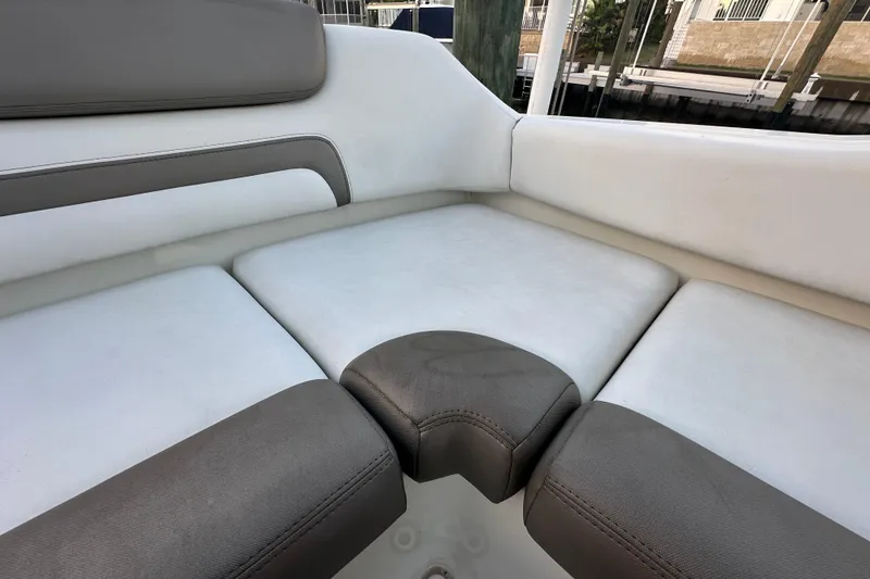 Slide: The Image of 2021 World Cat 230 SD boat interior seating with gray and white upholstery. - 82