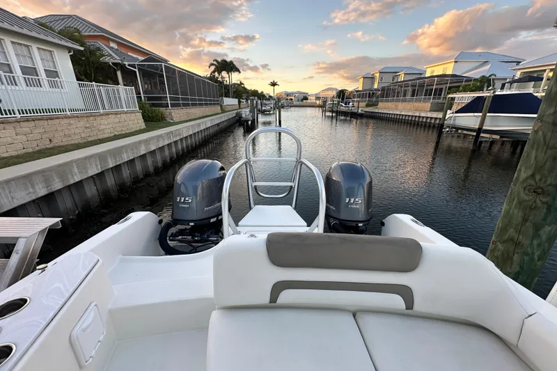 Slide: The Image of 2021 World Cat 230 SD boat with twin Yamaha 115 engines docked in a canal. - 86