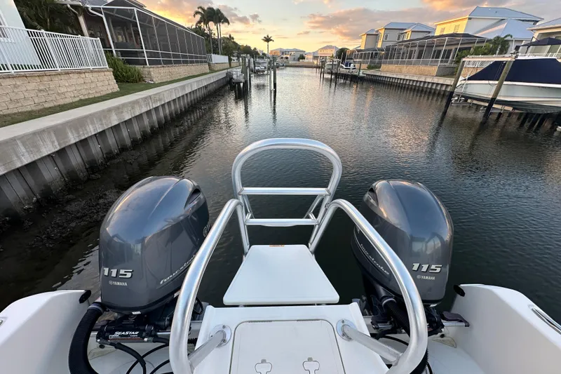 Slide: The Image of 2021 World Cat 230 SD boat with twin Yamaha 115 engines in a scenic canal. - 93