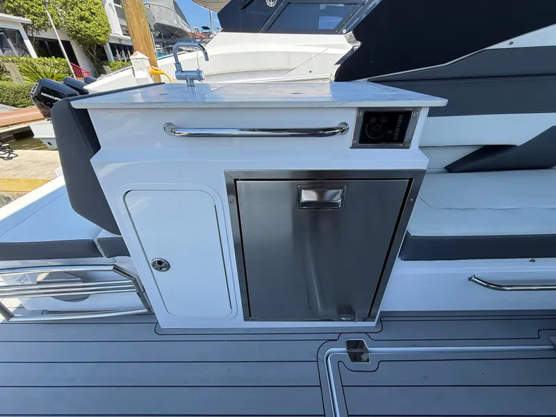 Slide: The Image of 2022 Cruisers Yachts 34 GLS OB with outdoor kitchen and stainless steel features. - 48