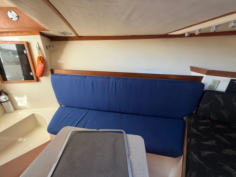 Slide: The Image of Interior of 2002 Albemarle 305 Express Fisherman with blue seating. - 23
