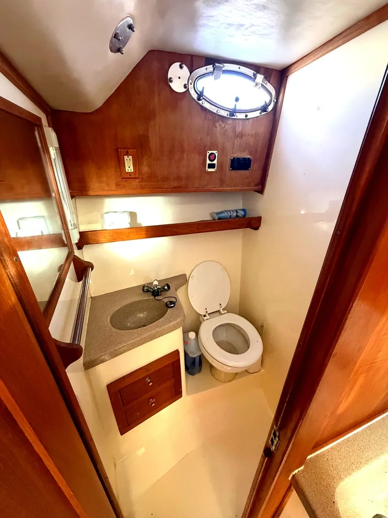 Slide: The Image of Interior view of the bathroom on a 2002 Albemarle 305 Express Fisherman boat. - 24