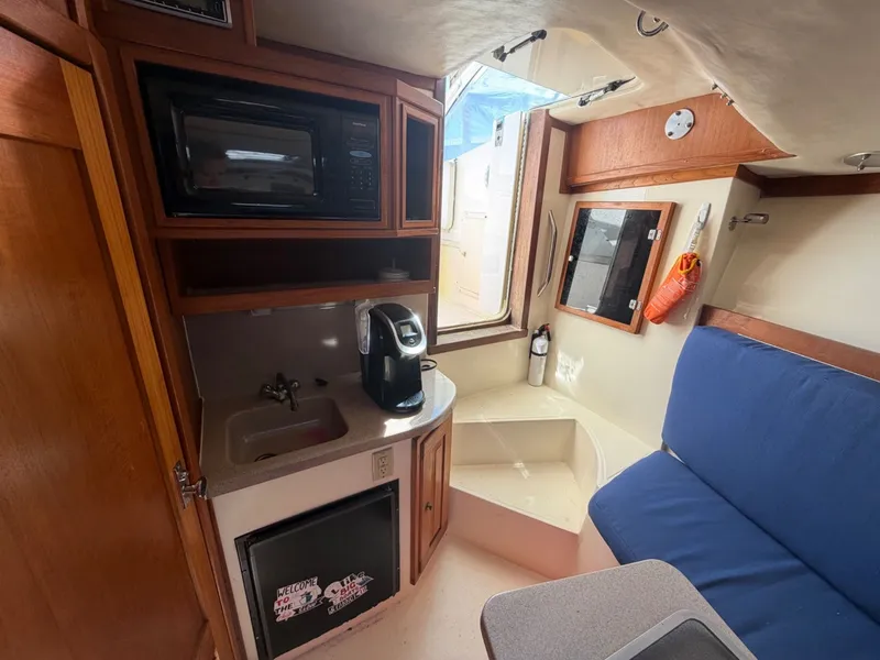 Slide: The Image of Interior of 2002 Albemarle 305 Express Fisherman with kitchenette and seating area. - 26