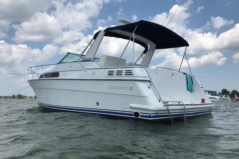 Slide: The Image of 1991 Four Winns 325 Express Vista boat on water under cloudy sky. - 16