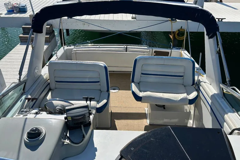 Slide: The Image of 1991 Four Winns 325 Express Vista boat interior with seating and steering wheel. - 5