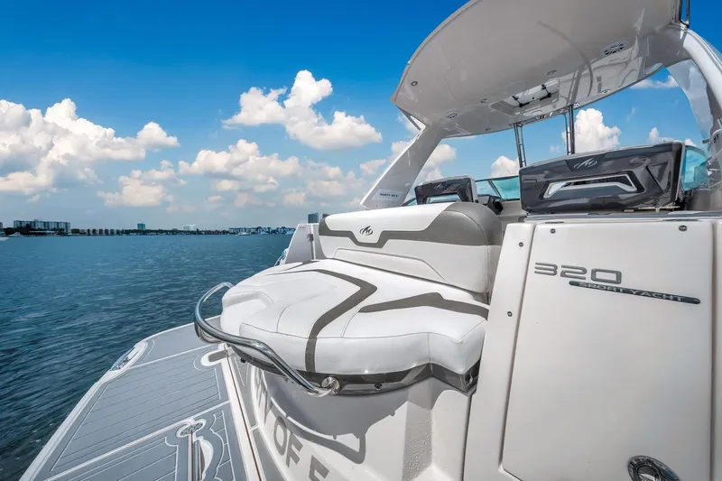 Slide: The Image of 2014 Monterey 320 Sport Yacht on water, showcasing sleek design and luxury seating. - 13