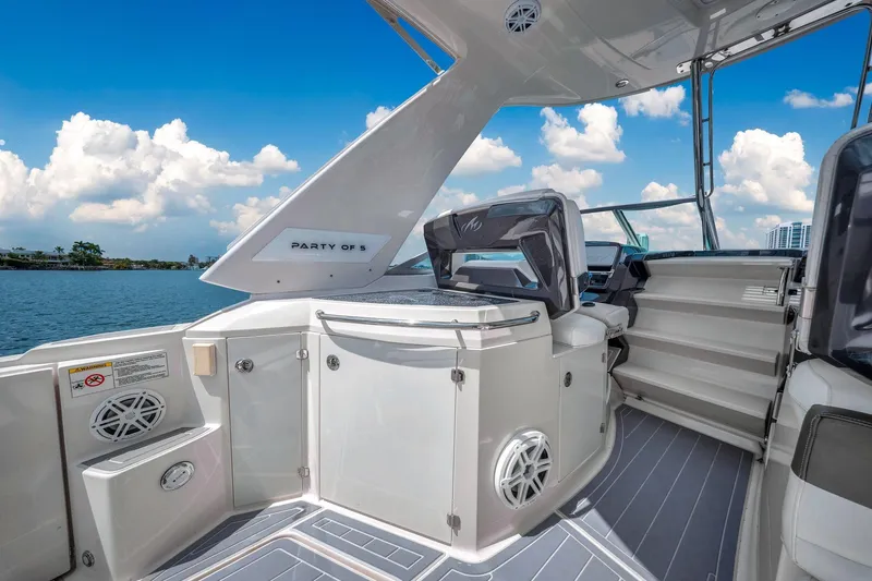 Slide: The Image of 2014 Monterey 320 Sport Yacht interior with seating, stairs, and water view. - 17