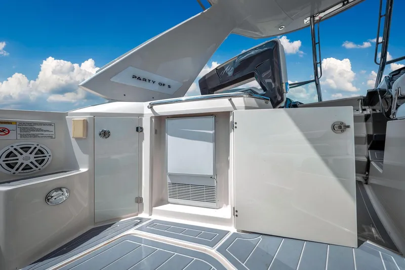 Slide: The Image of 2014 Monterey 320 Sport Yacht interior with open door, sleek design, and blue sky background. - 18