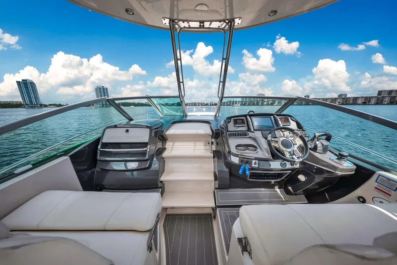 Slide: The Image of 2014 Monterey 320 Sport Yacht interior with modern dashboard and scenic ocean view. - 19