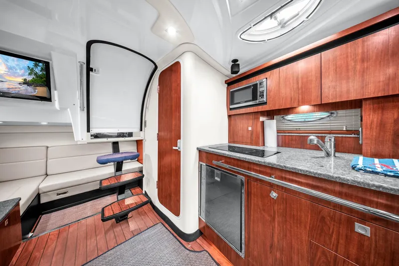 Slide: The Image of Luxurious interior of 2014 Monterey 320 Sport Yacht with modern kitchen and seating area. - 30