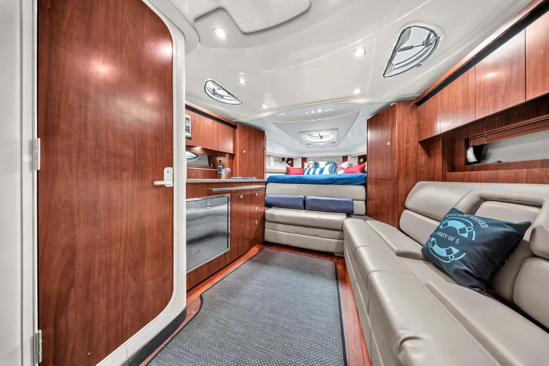 Slide: The Image of Luxurious interior of 2014 Monterey 320 Sport Yacht with wood finishes and comfortable seating. - 35