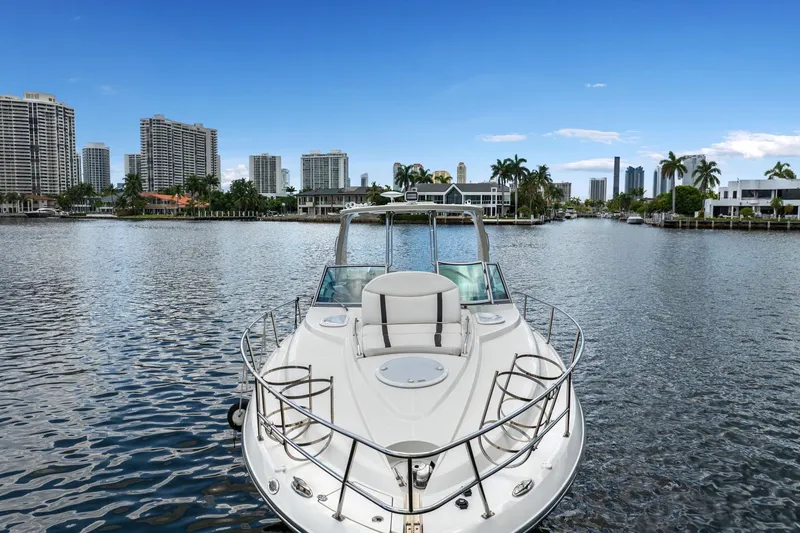 Slide: The Image of 2014 Monterey 320 Sport Yacht on a scenic urban waterway with skyscrapers. - 7
