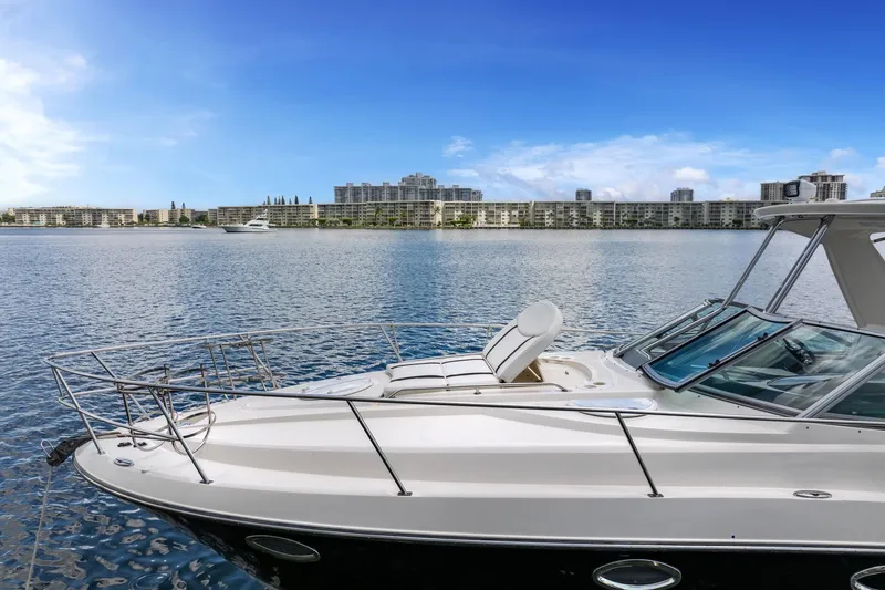 Slide: The Image of 2014 Monterey 320 Sport Yacht on calm water with cityscape background. - 9
