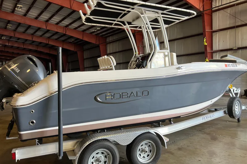 Slide: The Image of 2023 Robalo R200 Center Console boat on trailer in warehouse. - 1