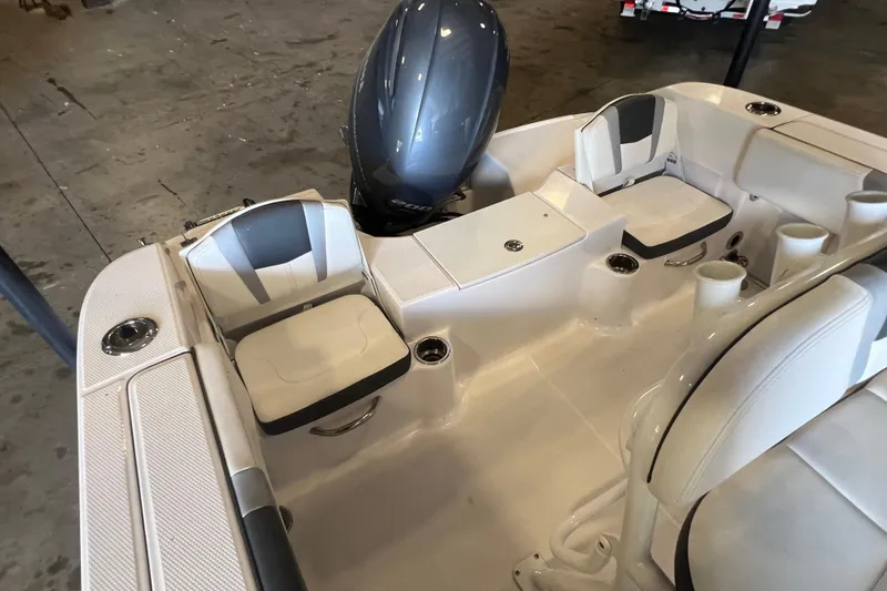 Slide: The Image of 2023 Robalo R200 Center Console boat interior with seating and engine view. - 10