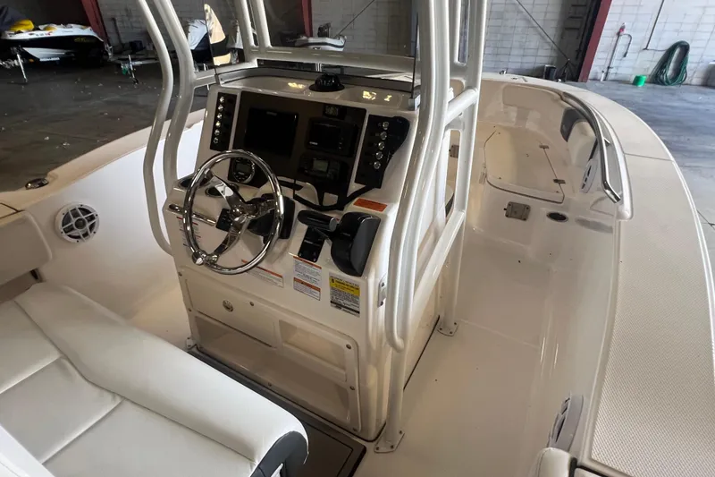 Slide: The Image of 2023 Robalo R200 Center Console boat interior with steering wheel and control panel. - 11