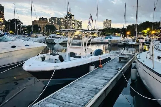 Slide: The Image of 2023 Robalo R200 Center Console boat docked at a marina during twilight. - 15