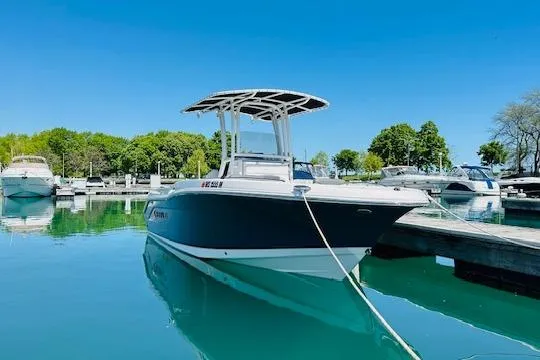 Slide: The Image of 2023 Robalo R200 Center Console boat docked in a serene marina setting. - 17
