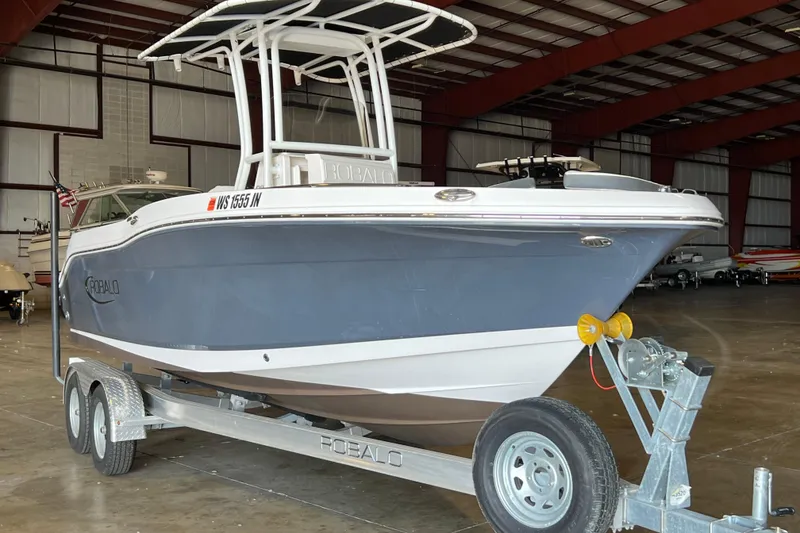 Slide: The Image of 2023 Robalo R200 Center Console boat on trailer in indoor storage facility. - 2