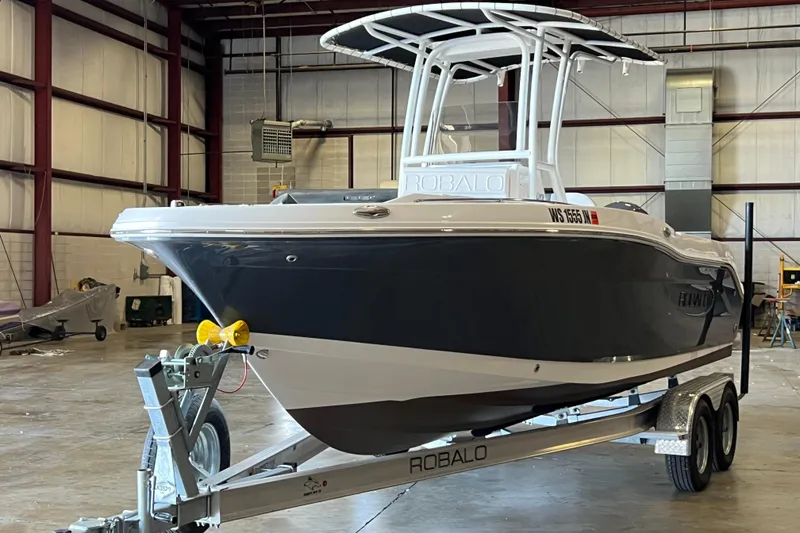 Slide: The Image of 2023 Robalo R200 Center Console boat on trailer in warehouse setting. - 3