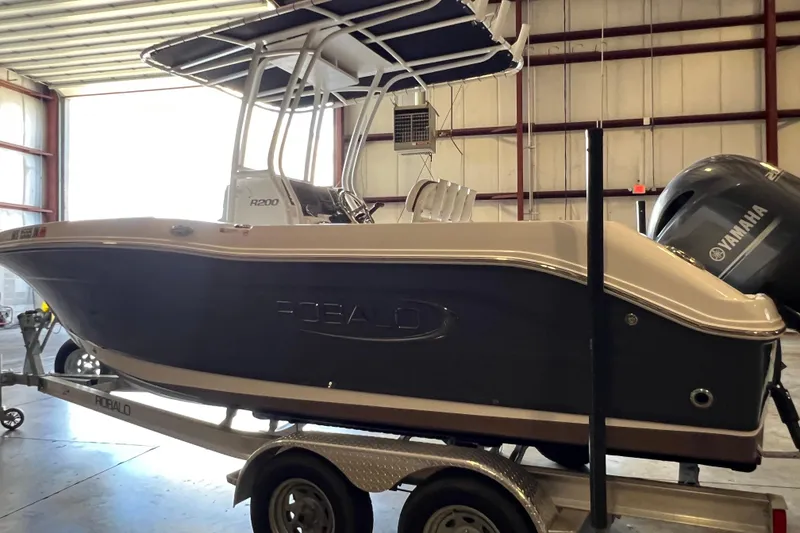 Slide: The Image of 2023 Robalo R200 Center Console boat on trailer in warehouse. - 5