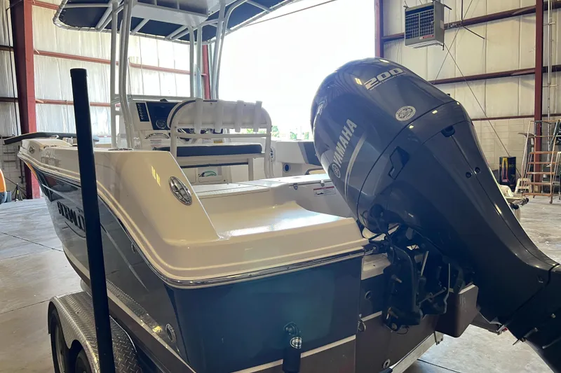 Slide: The Image of 2023 Robalo R200 Center Console boat with Yamaha engine in a warehouse. - 6