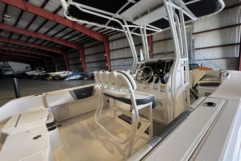 Slide: The Image of 2023 Robalo R200 Center Console boat interior in a spacious warehouse setting. - 8