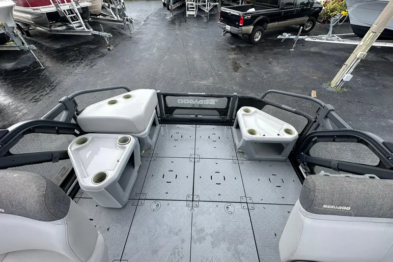 Slide: The Image of 2023 Sea-Doo Switch Cruise 21 interior with seating and cup holders, parked on a lot. - 13
