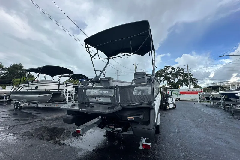 Slide: The Image of 2023 Sea-Doo Switch Cruise 21 pontoon boat on trailer in a dealership lot. - 3
