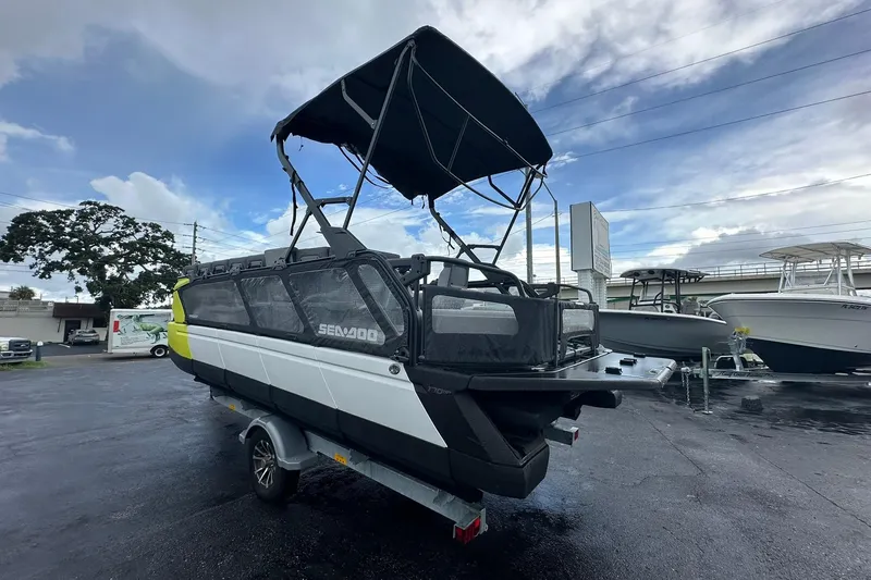 Slide: The Image of 2023 Sea-Doo Switch Cruise 21 boat on trailer, parked outdoors under cloudy sky. - 5