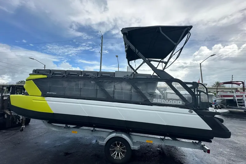 Slide: The Image of 2023 Sea-Doo Switch Cruise 21 pontoon boat on trailer, featuring sleek design and vibrant colors. - 6