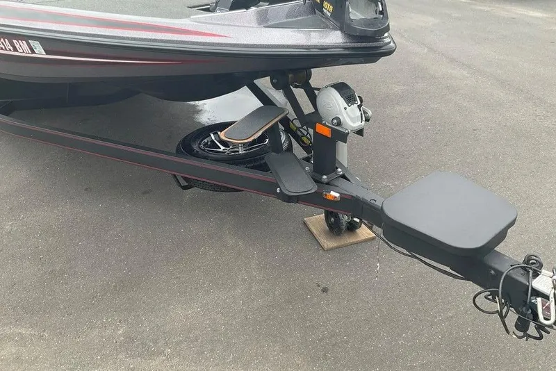 Slide: The Image of 2017 Skeeter FX21 LE boat trailer with winch and step, parked on asphalt. - 14