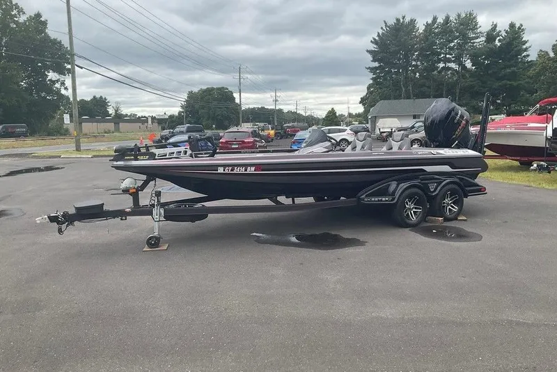 Slide: The Image of 2017 Skeeter FX21 LE bass boat on trailer in parking lot, overcast sky. - 15