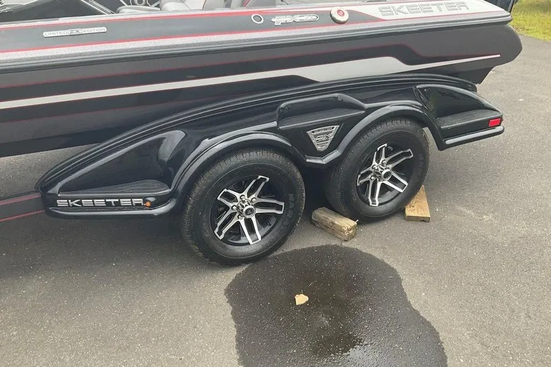 Slide: The Image of 2017 Skeeter FX21 LE boat trailer with dual wheels on pavement. - 29