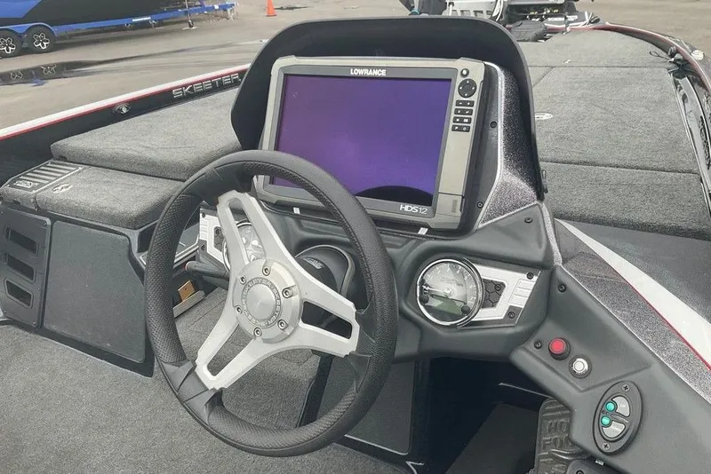 Slide: The Image of 2017 Skeeter FX21 LE boat dashboard with steering wheel and Lowrance HDS12 display. - 30