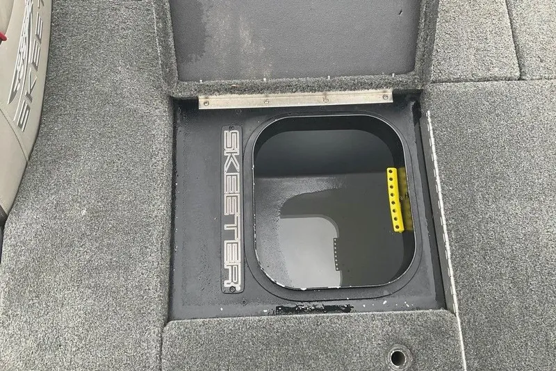 Slide: The Image of 2017 Skeeter FX21 LE boat storage compartment with open lid, showing interior details. - 43
