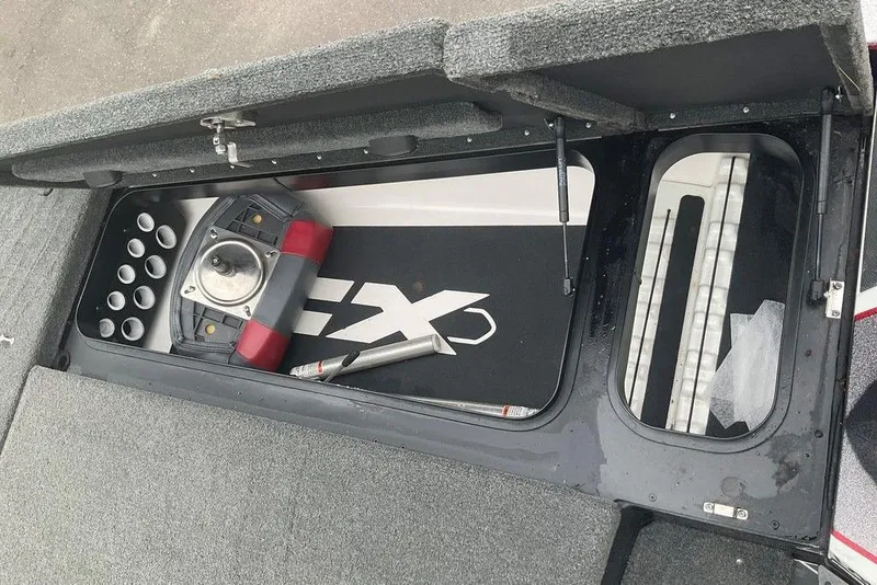 Slide: The Image of 2017 Skeeter FX21 LE boat storage compartment with fishing rod holders and equipment. - 47