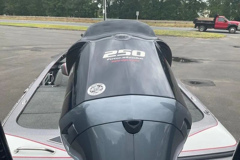 Slide: The Image of 2017 Skeeter FX21 LE boat with a 250 horsepower outboard motor, parked outdoors. - 6