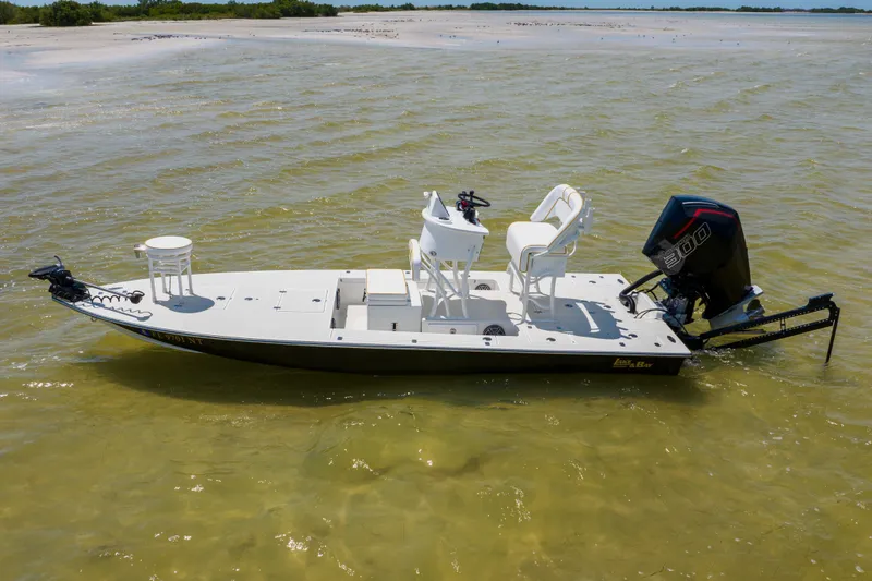 Slide: The Image of 2008 Lake & Bay Boca Grande 20 boat on calm water near sandy shore. - 13