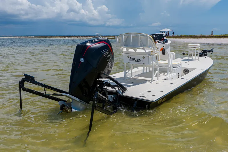 Slide: The Image of 2008 Lake & Bay Boca Grande 20 boat in shallow water, featuring powerful outboard motor. - 15