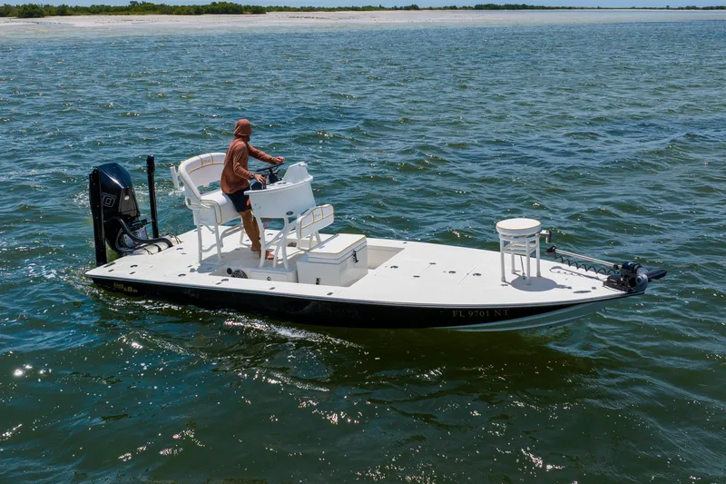 Slide: The Image of 2008 Lake & Bay Boca Grande 20 boat on open water, person steering. - 18