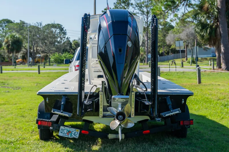 Slide: The Image of 2008 Lake & Bay Boca Grande 20 boat on trailer, rear view, parked on grass. - 2