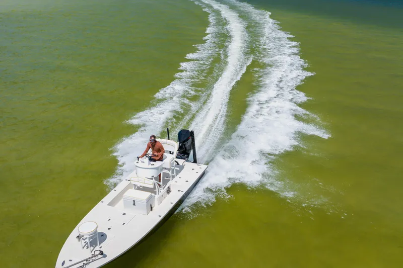 Slide: The Image of 2008 Lake & Bay Boca Grande 20 boat cruising on green water, leaving a wake trail. - 22