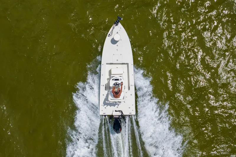 Slide: The Image of Aerial view of 2008 Lake & Bay Boca Grande 20 boat cruising on green water. - 25