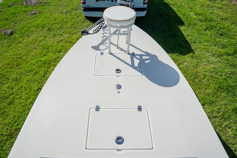 Slide: The Image of 2008 Lake & Bay Boca Grande 20 boat deck with storage hatches and seat, on grass. - 29