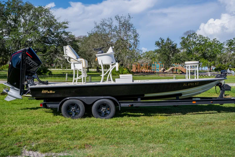 Slide: The Image of 2008 Lake & Bay Boca Grande 20 boat on trailer, parked on grass. - 3