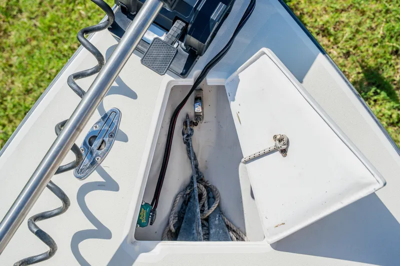 Slide: The Image of 2008 Lake & Bay Boca Grande 20 boat anchor compartment with rope and metal fittings. - 35