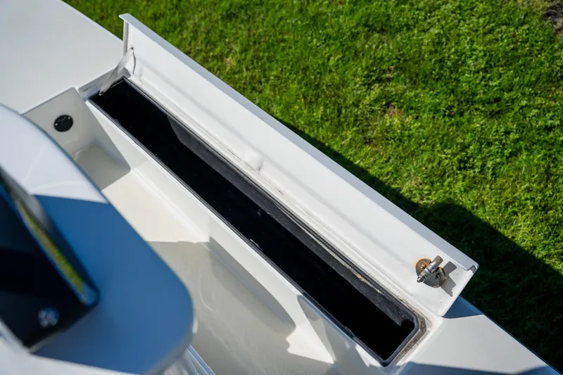 Slide: The Image of 2008 Lake & Bay Boca Grande 20 boat compartment open on grassy background. - 39