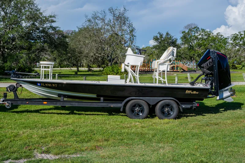 Slide: The Image of 2008 Lake & Bay Boca Grande 20 boat on trailer, parked on grass. - 4
