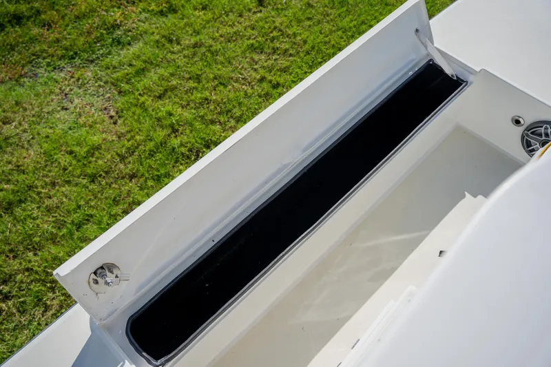 Slide: The Image of Open storage compartment on 2008 Lake & Bay Boca Grande 20 boat, grassy background. - 40